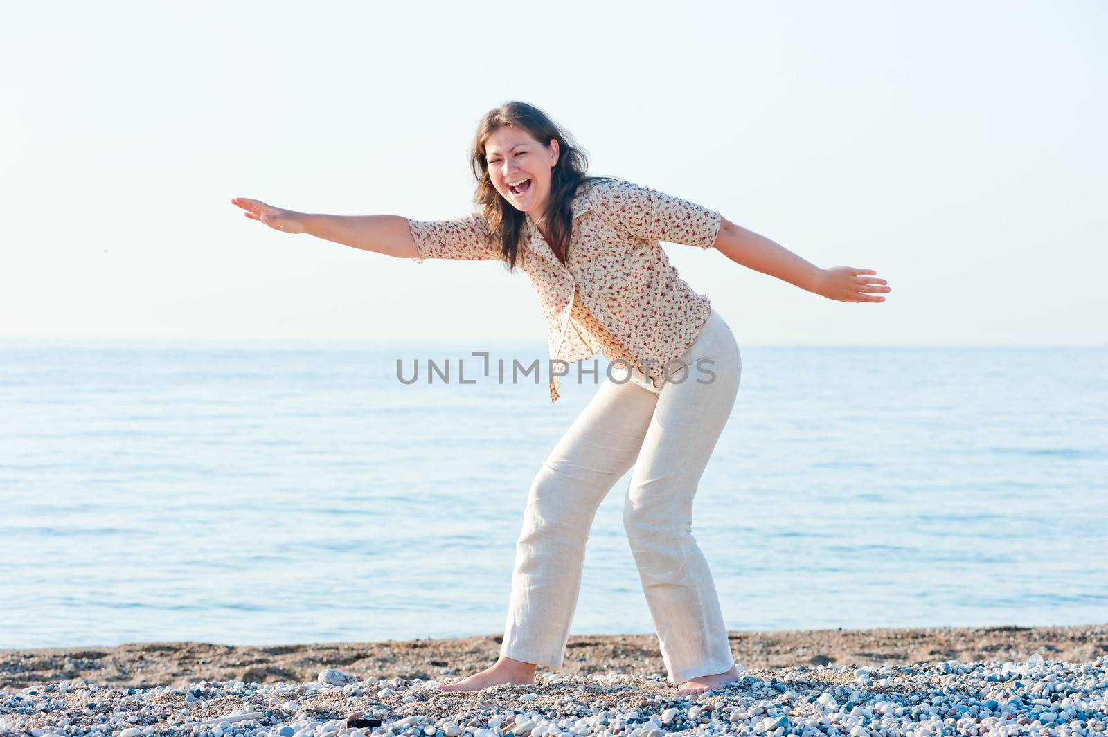 young girl on the beach fooling around by kosmsos111