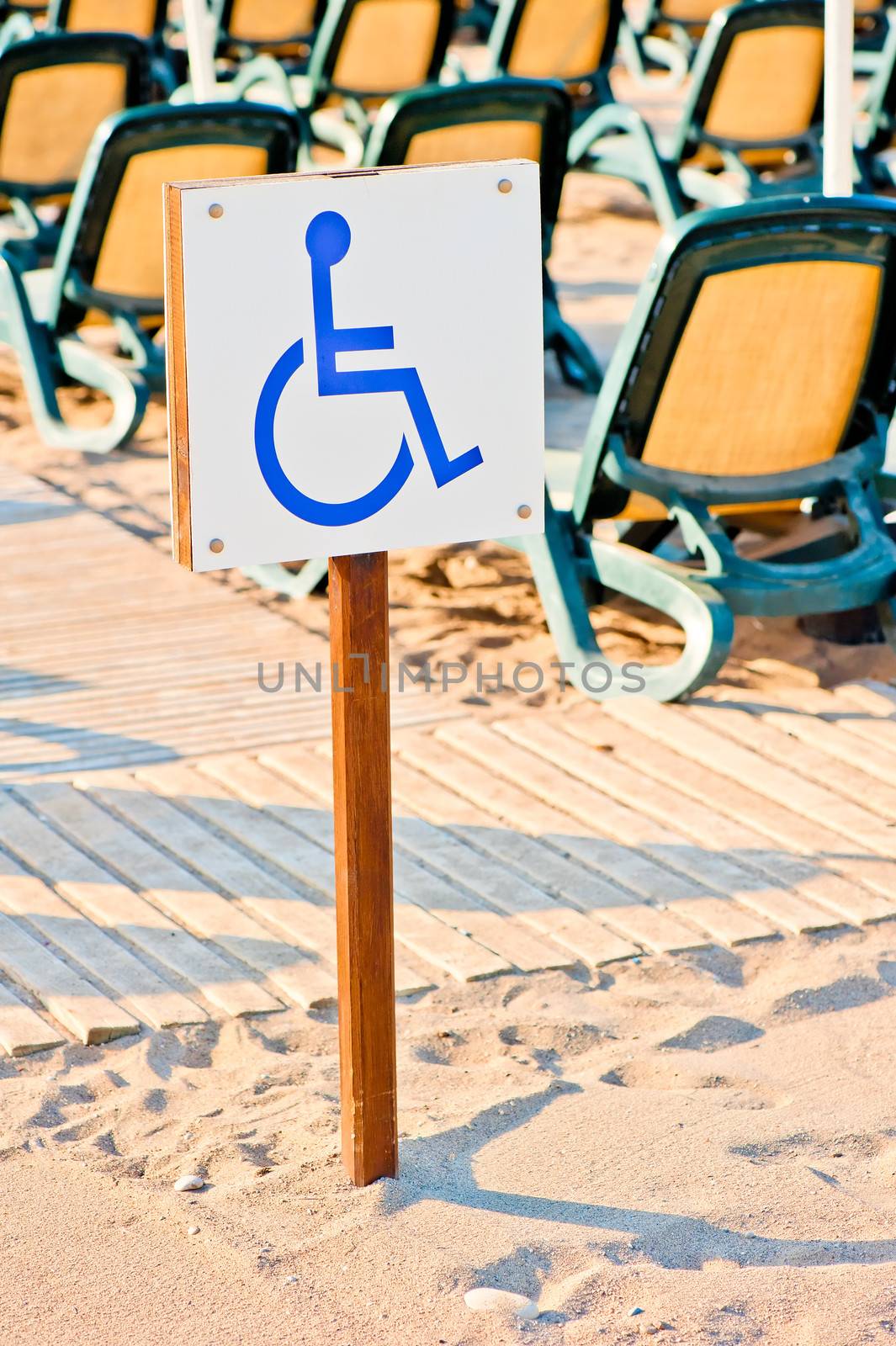 sign wheelchair set on the beach by the sea by kosmsos111
