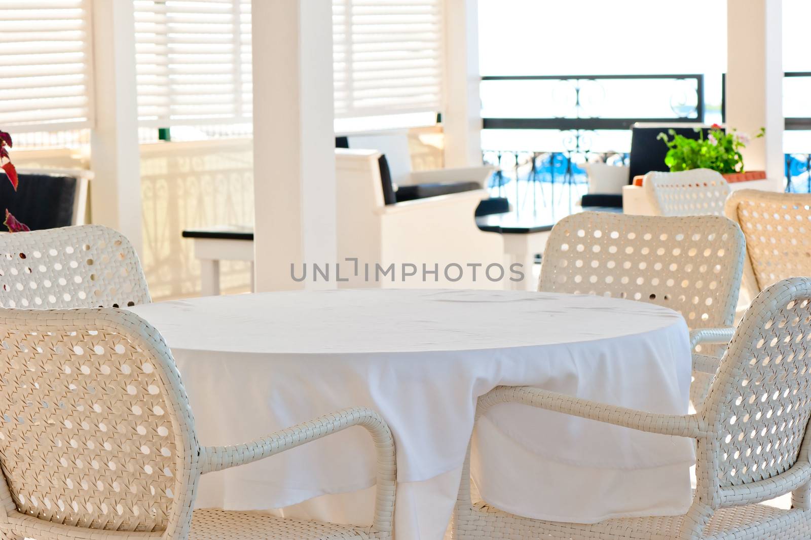 in the cafeteria wicker chairs and tables covered with cloth