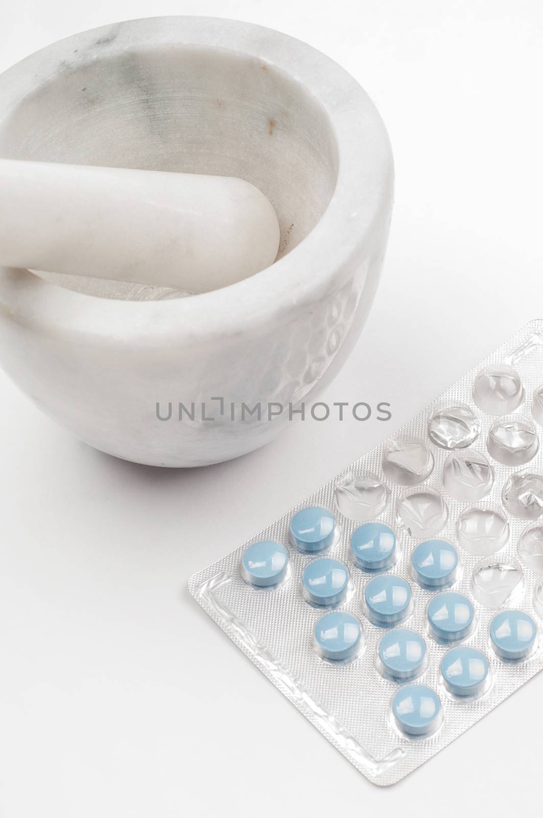 Shot of blue drugs (tablets) with marble mortar