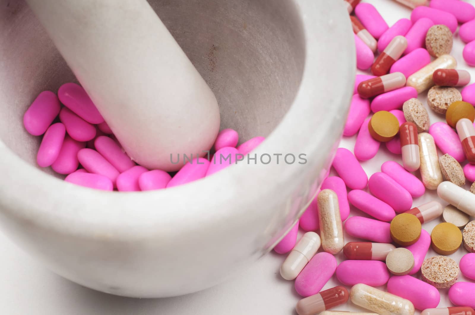 Shot of pink drugs with marble mortar grinding machine