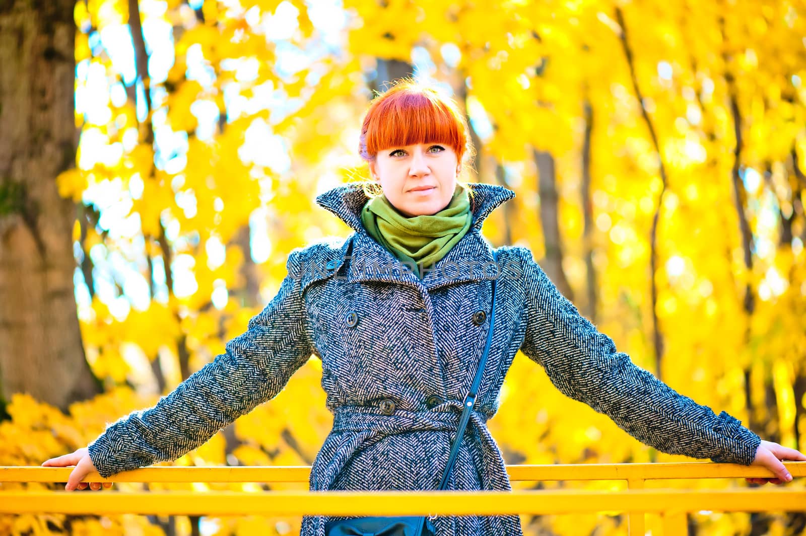 woman in a coat walks on autumn park by kosmsos111