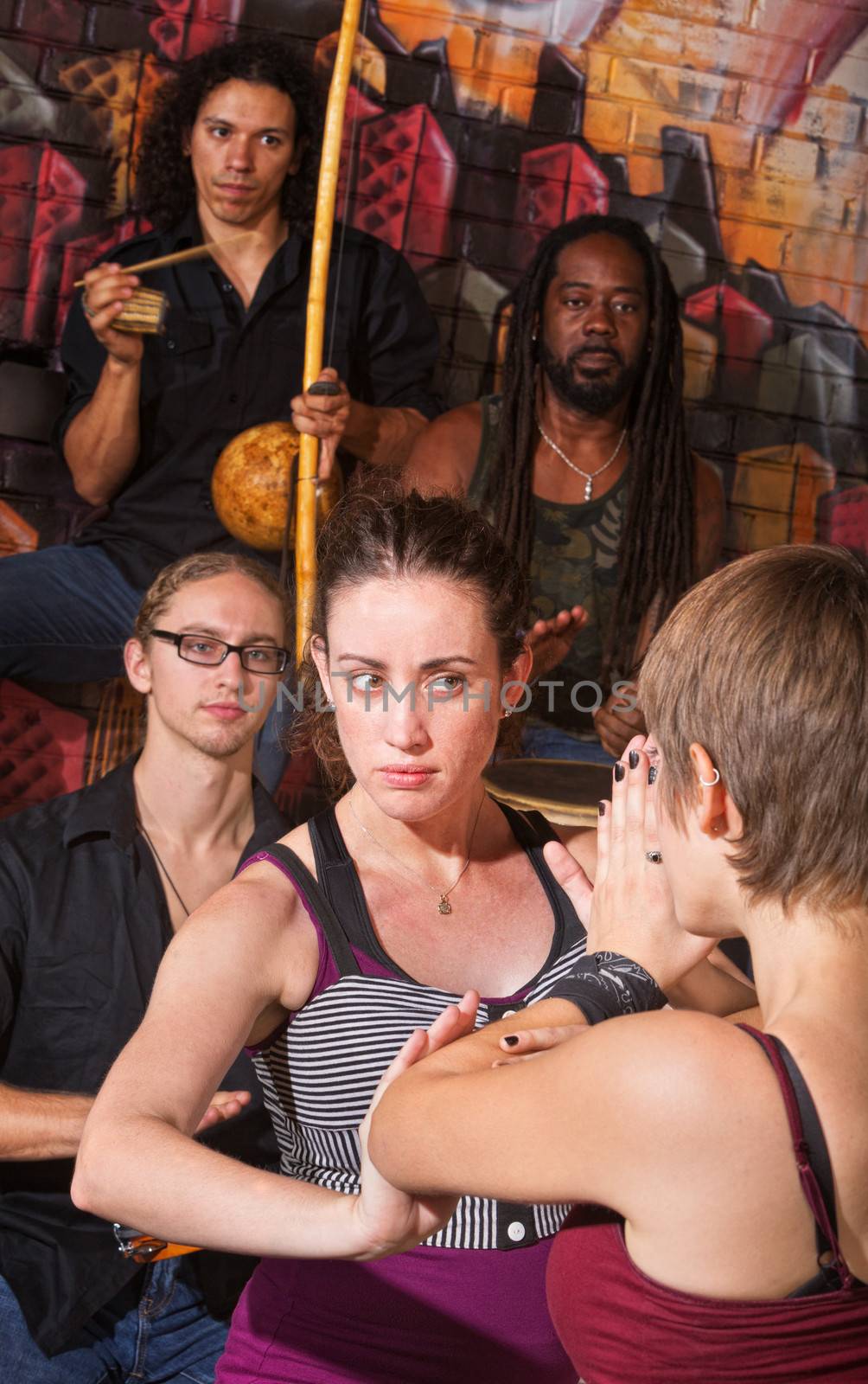 Serious capoeira blocking an attack with partner