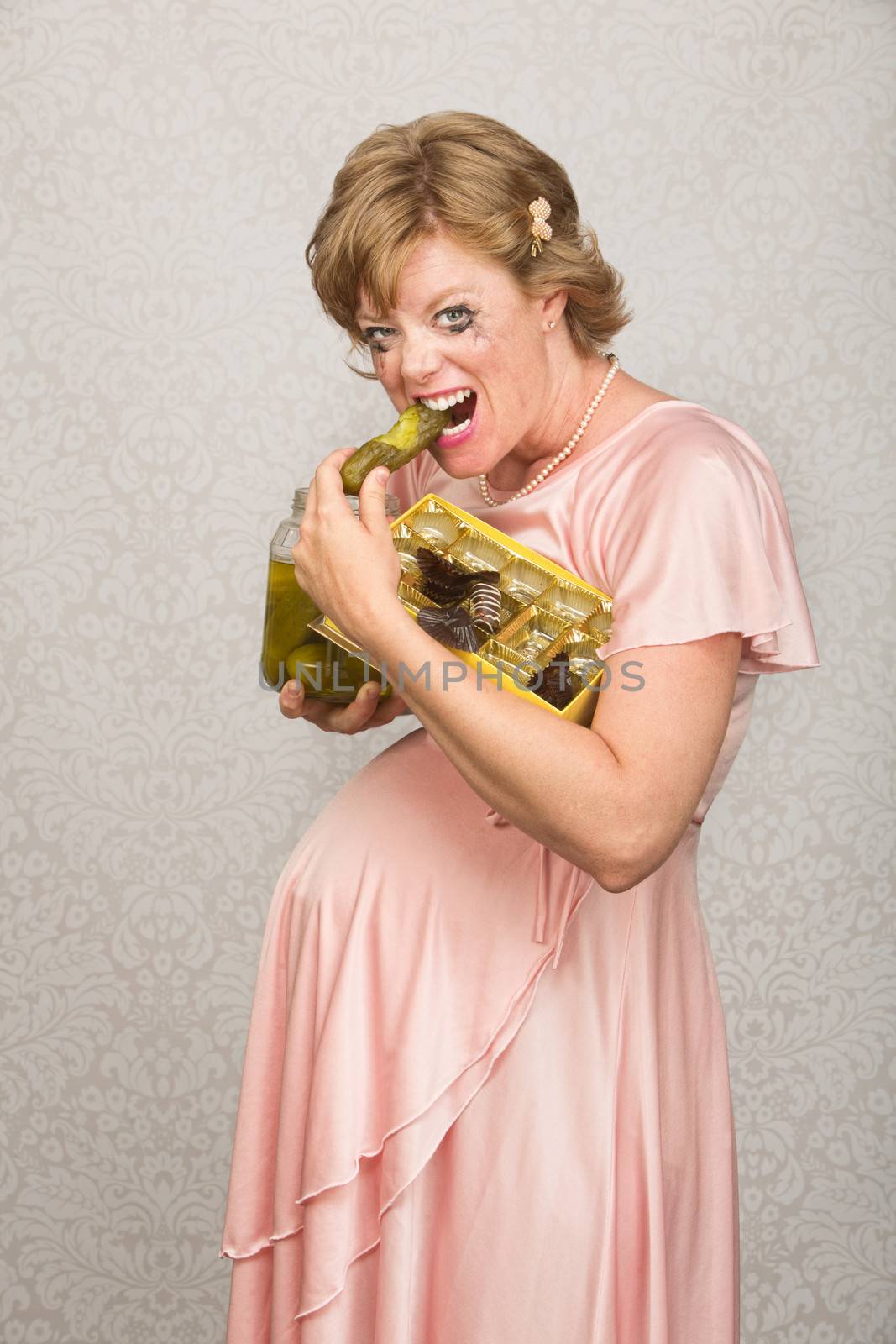 European pregnant lady eating pickles and chocolate