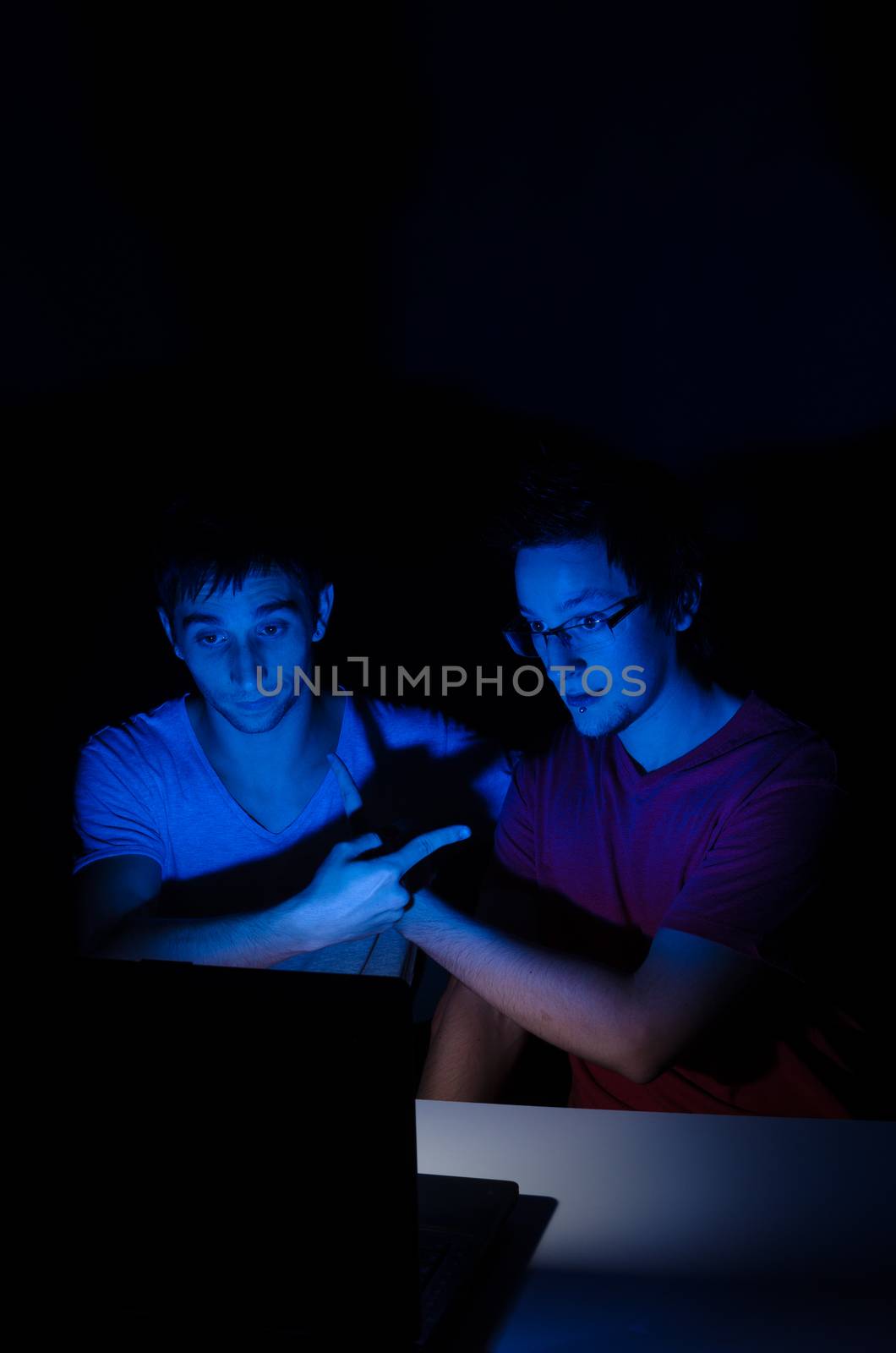 Two friends chatting on a laptop with webcam