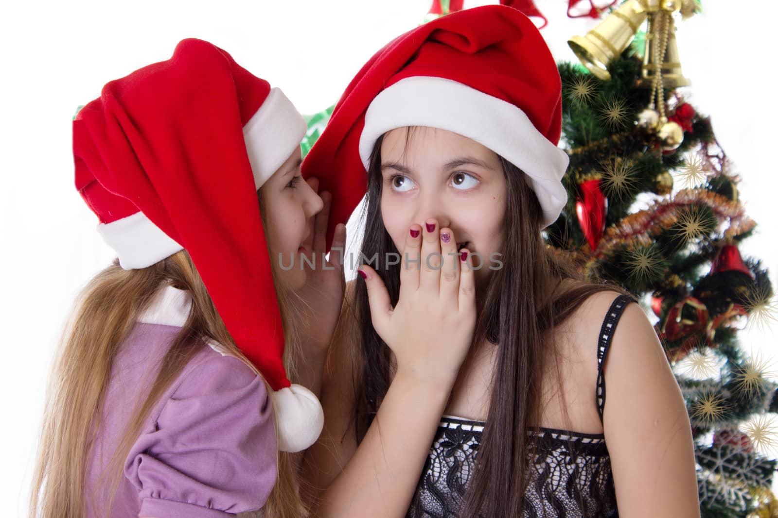 Two eleven years old girls sharing each other secrets on Christmas Eve