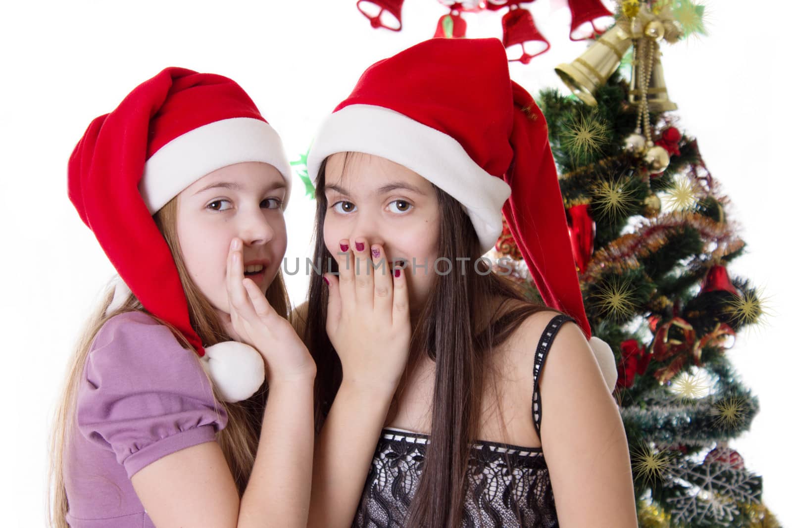 Two eleven years old girls sharing each other secrets on Christmas Eve