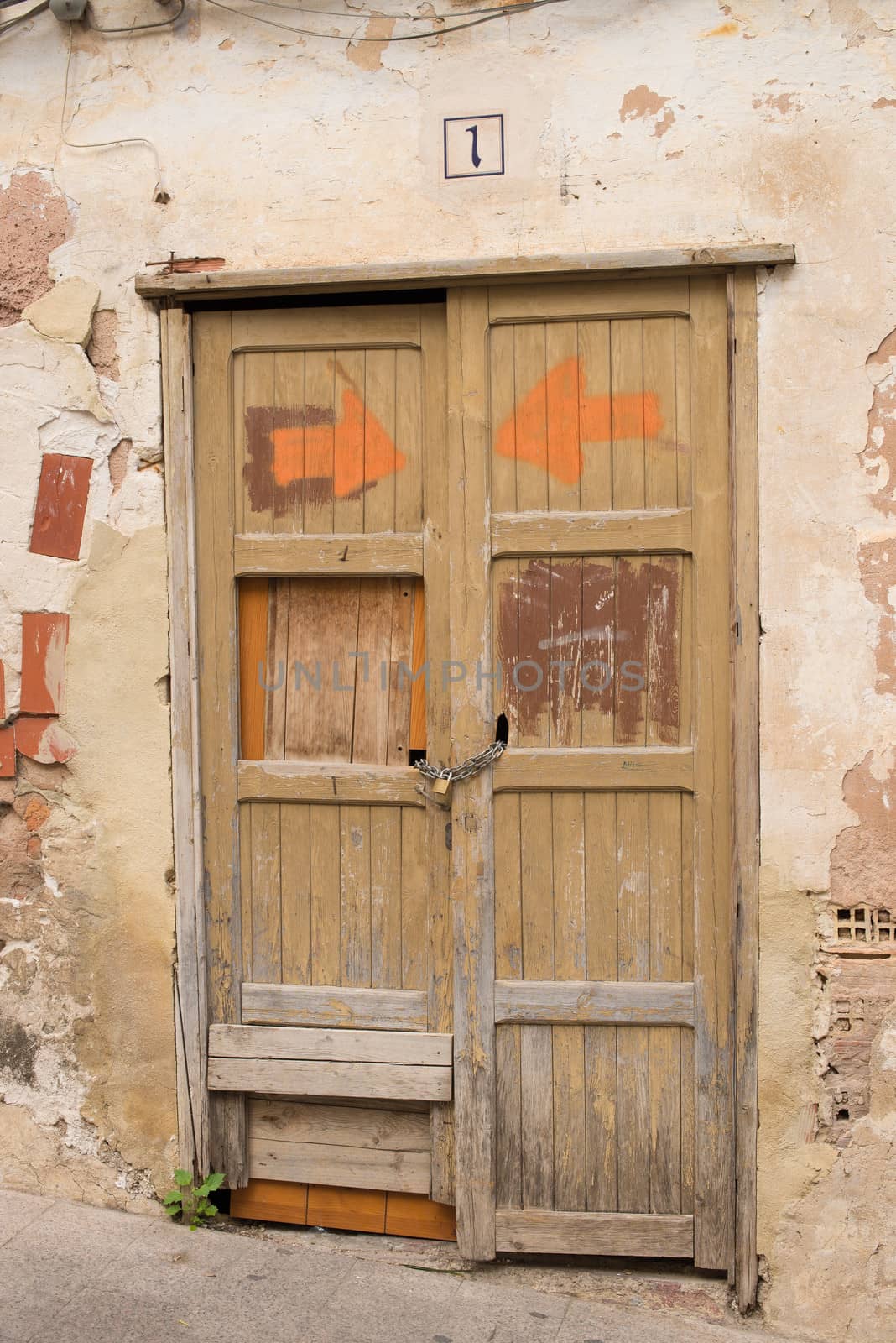 Old door on a drelict building facade