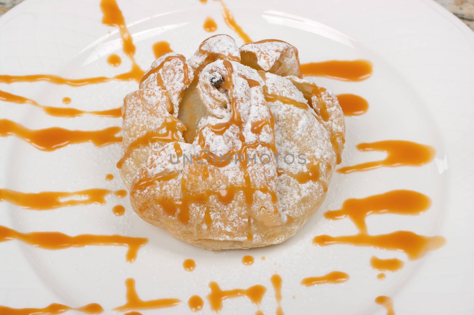 Poached pear dessert filled with pecans, blue cheese and caramel sauce