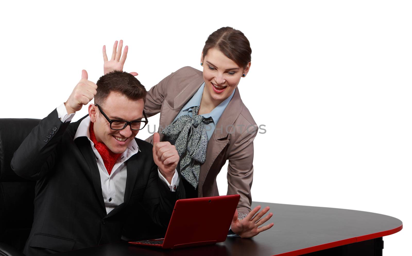 Young happy couple getting good new from a notebook, isolated against a white background.