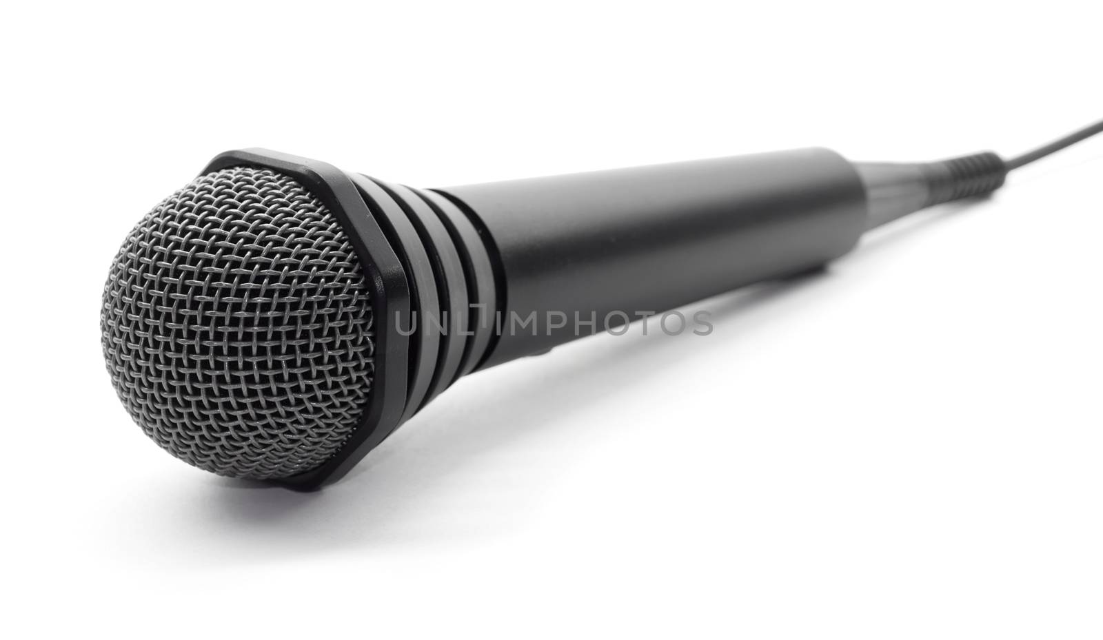 Plugged in black microphone on white background