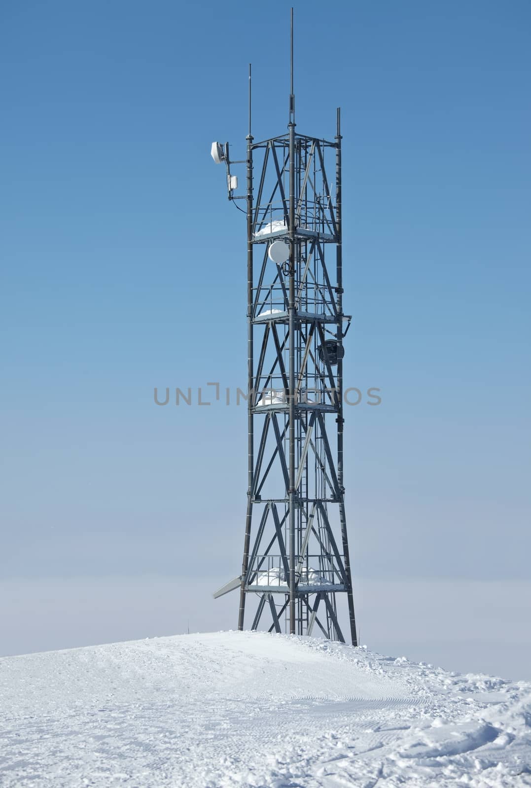 High transmitter tower against overcast sky