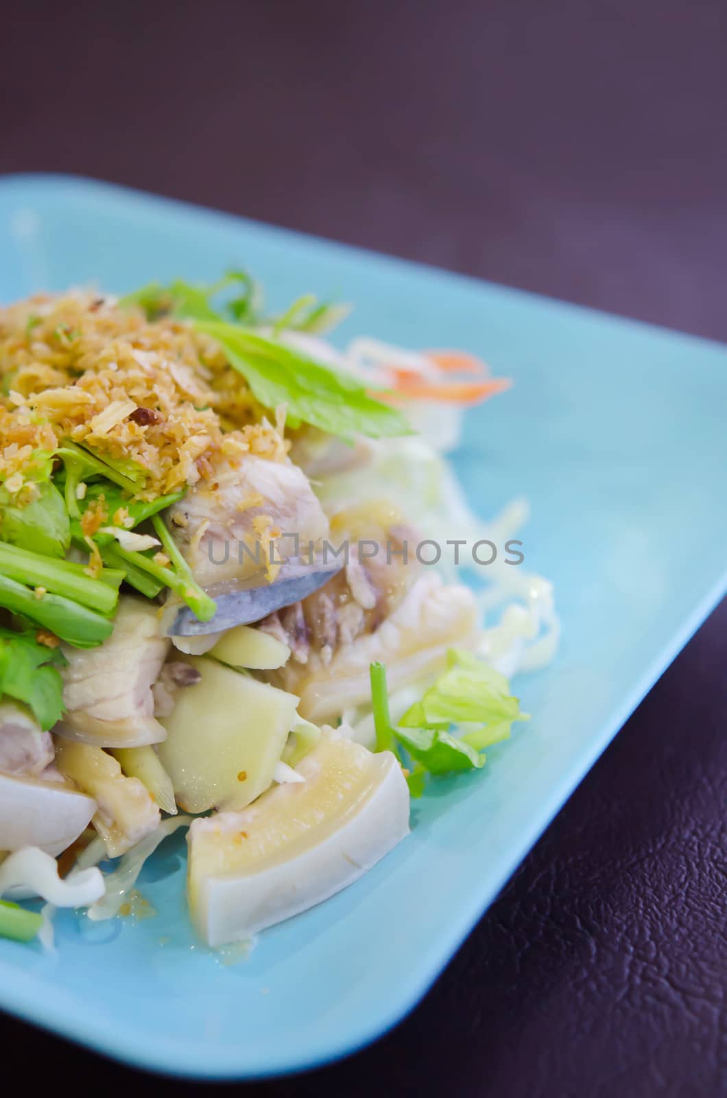  close up steamed fish with fried garlic and fresh vegetable , asian style cuisine