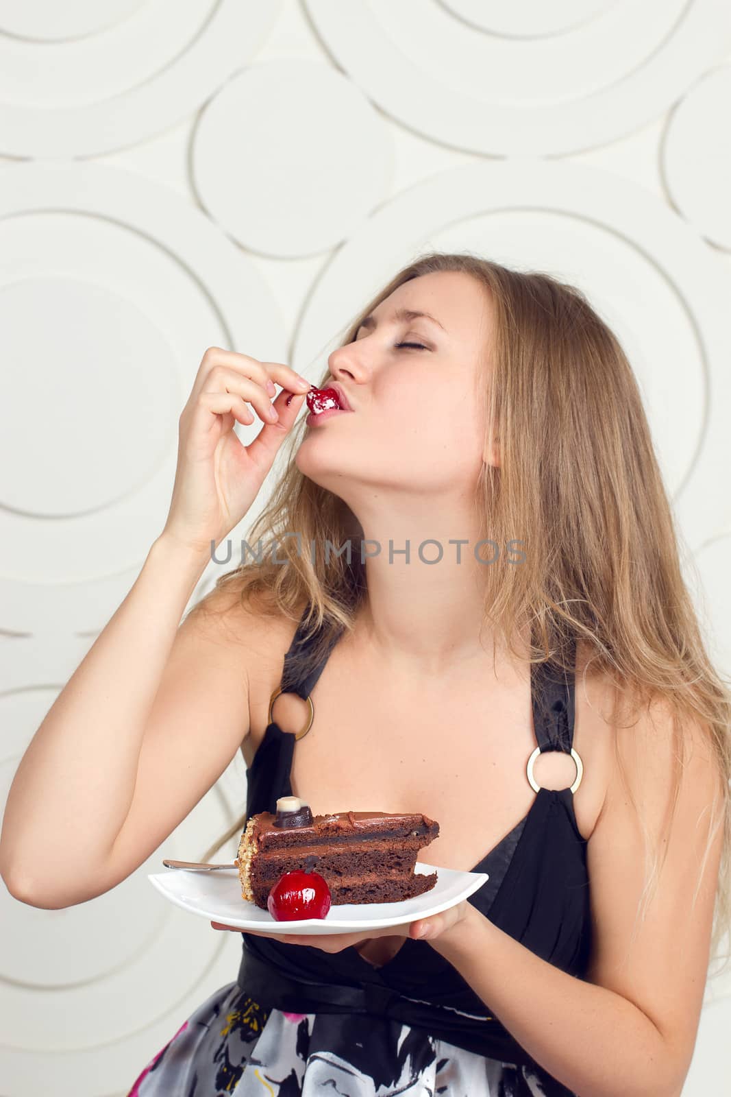 Portrait of young woman enjoying the cake