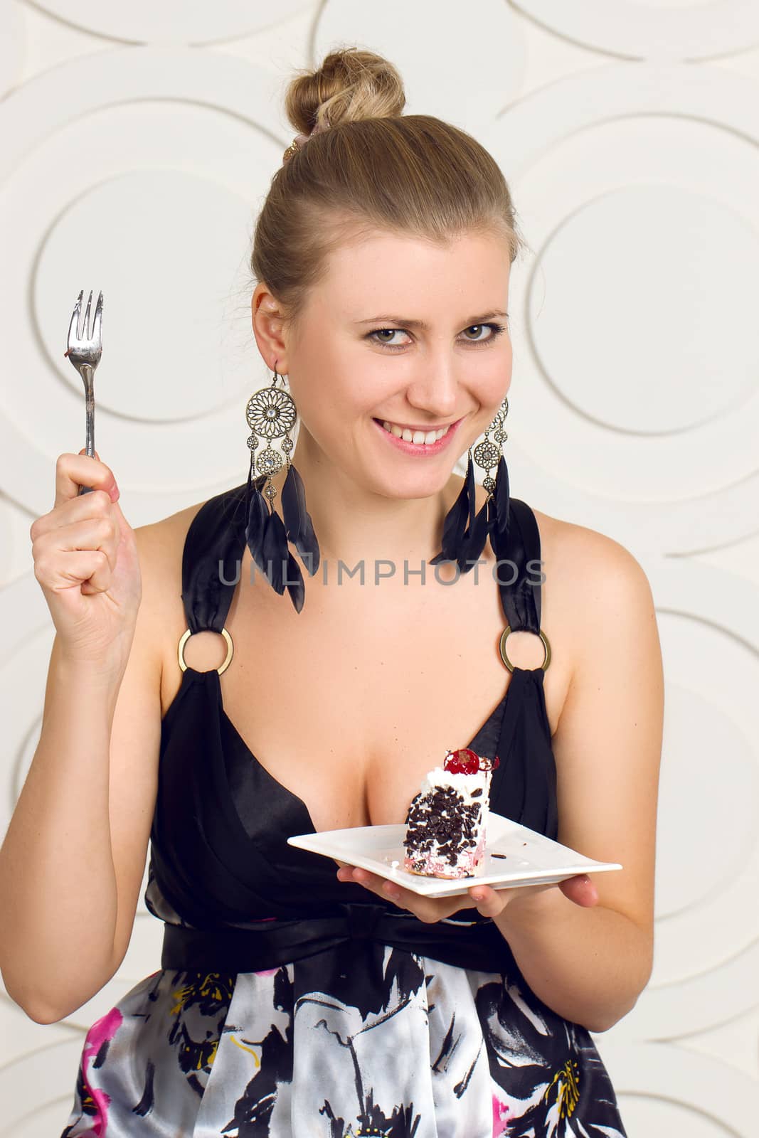 Young beautiful woman eating  chocolate cake.