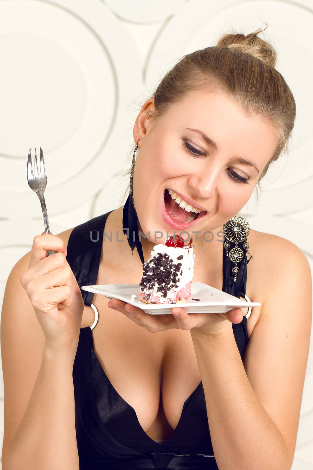 Young beautiful woman eating  chocolate cake.