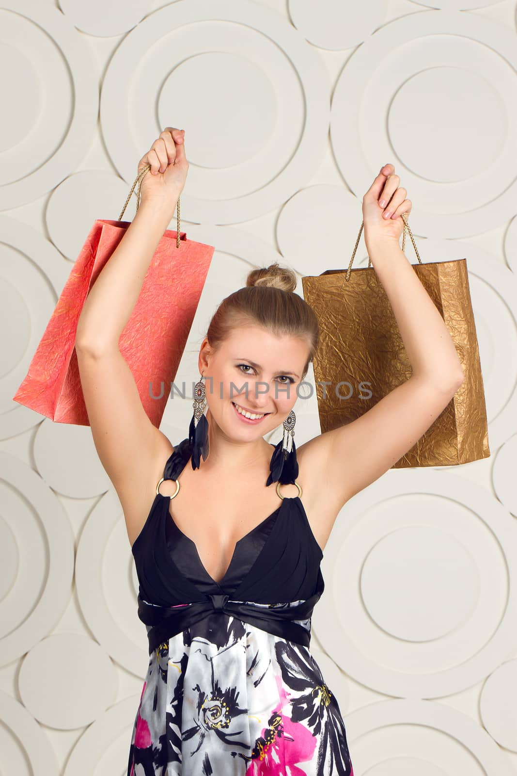 Happy woman holding shopping bags and smiling