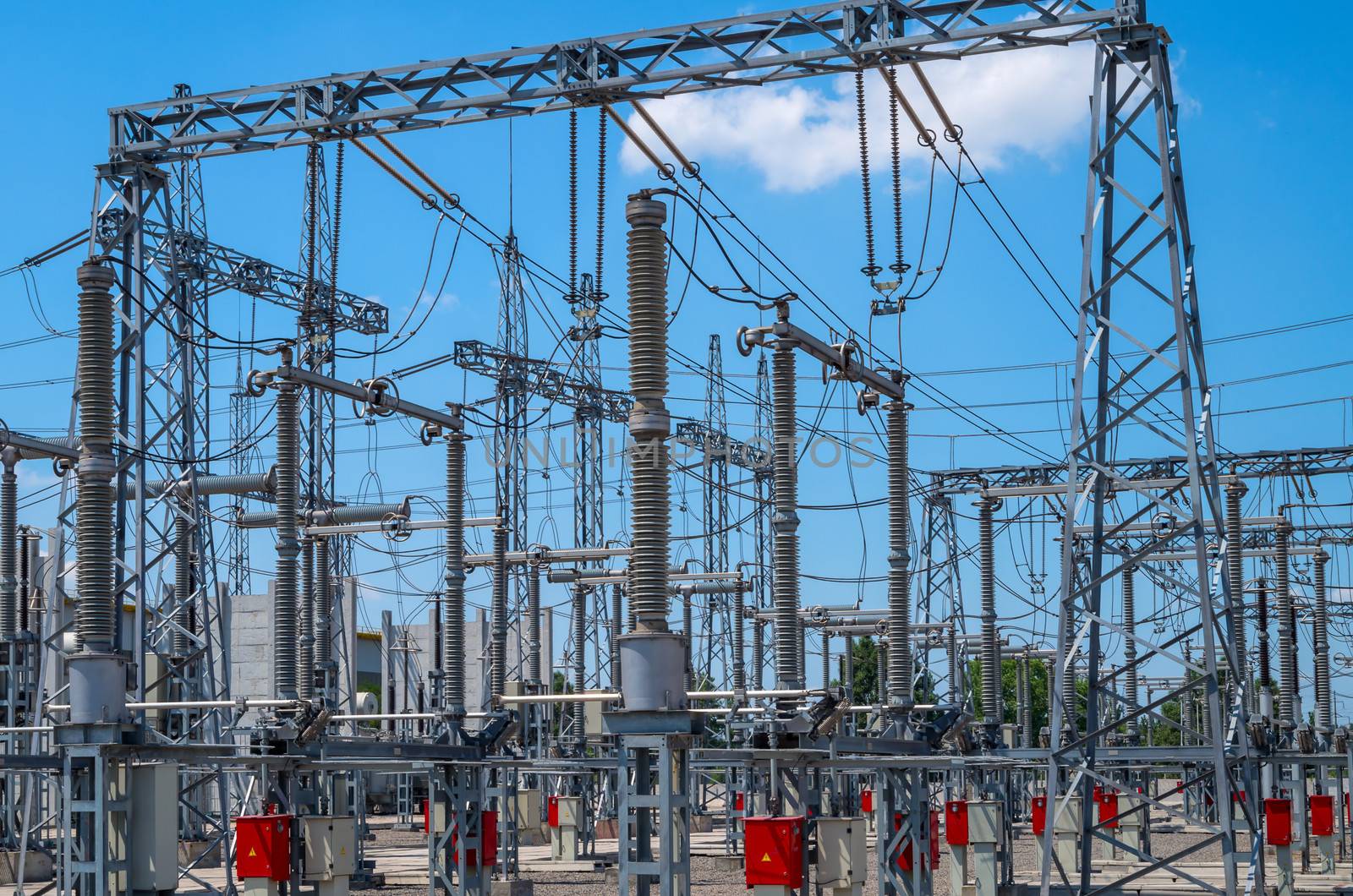Image of high voltage transformer station against the blue sky.