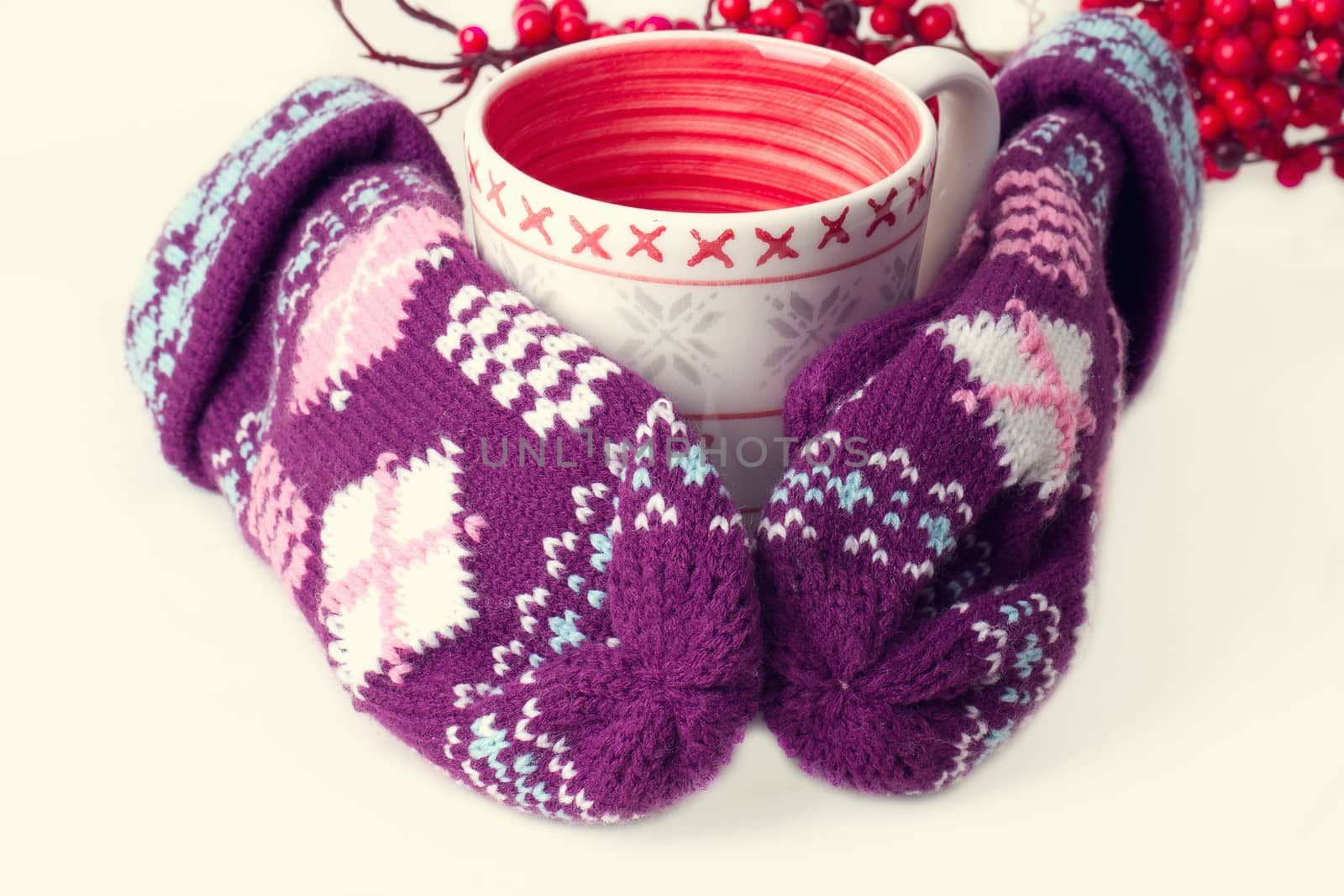 Cozy red gloves hold a mug of hot cocoa