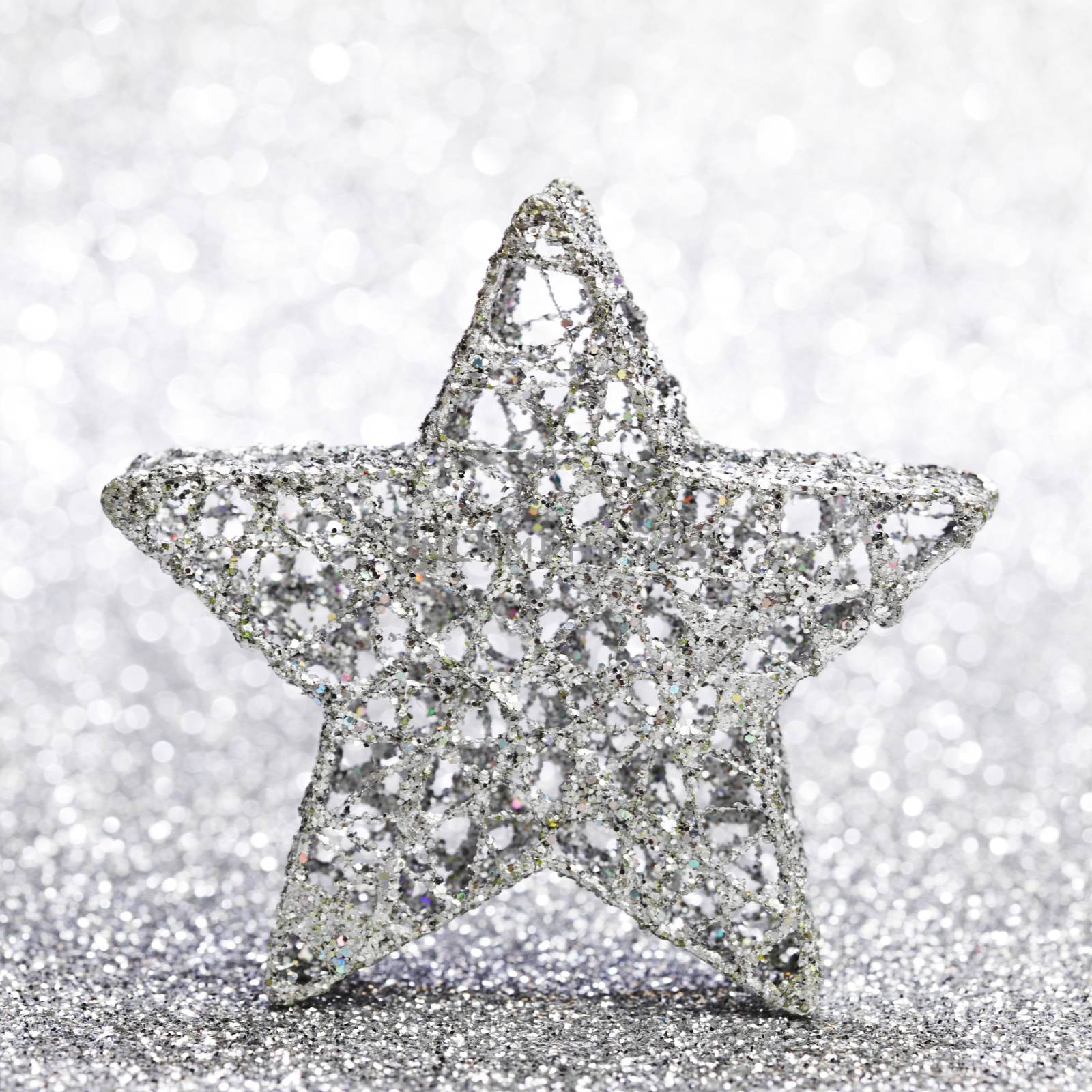 Beautiful christmas star decoration over shiny glitter background