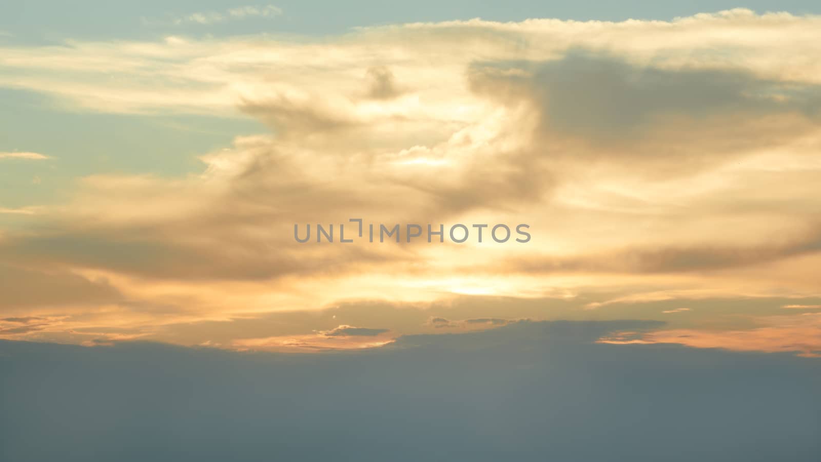 Skyscape in the  evening time. Sun beams punched through the clouds