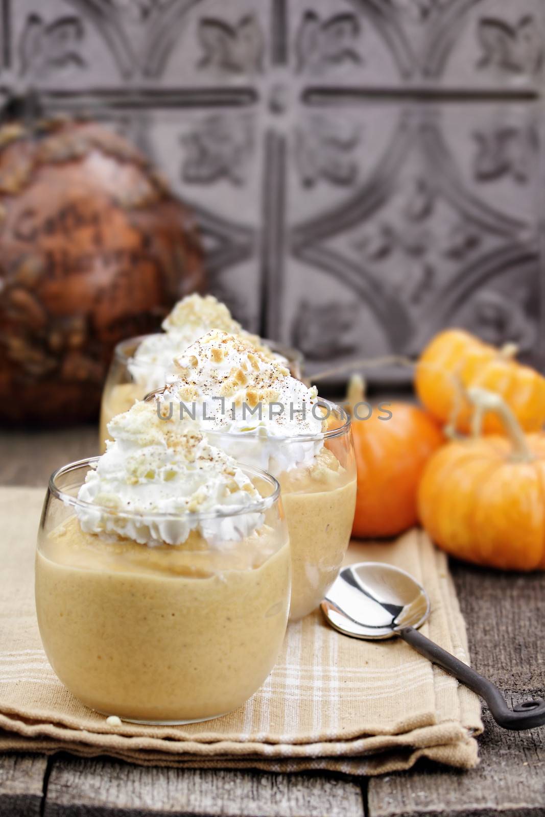 Three fresh Pumpkin Smoothies against a rustic background. 