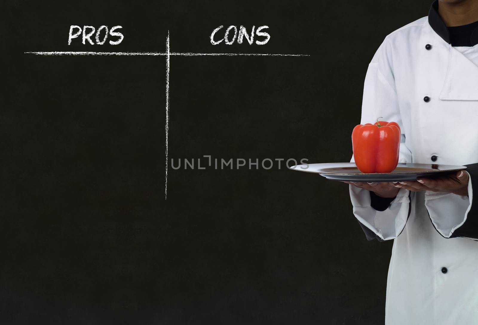 African American chef holding healthy food with chalk pros and cons on blackboard background by alistaircotton