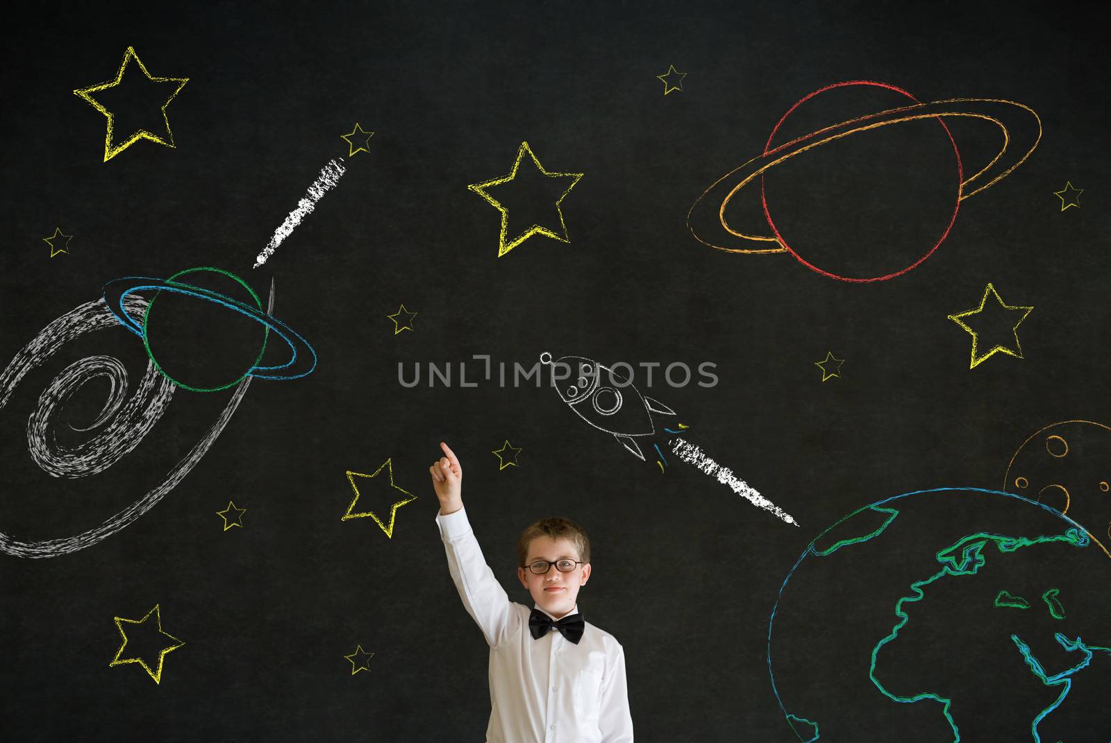 Hand up answer boy dressed up as business man with chalk universe planet solar system on blackboard imagining space travel