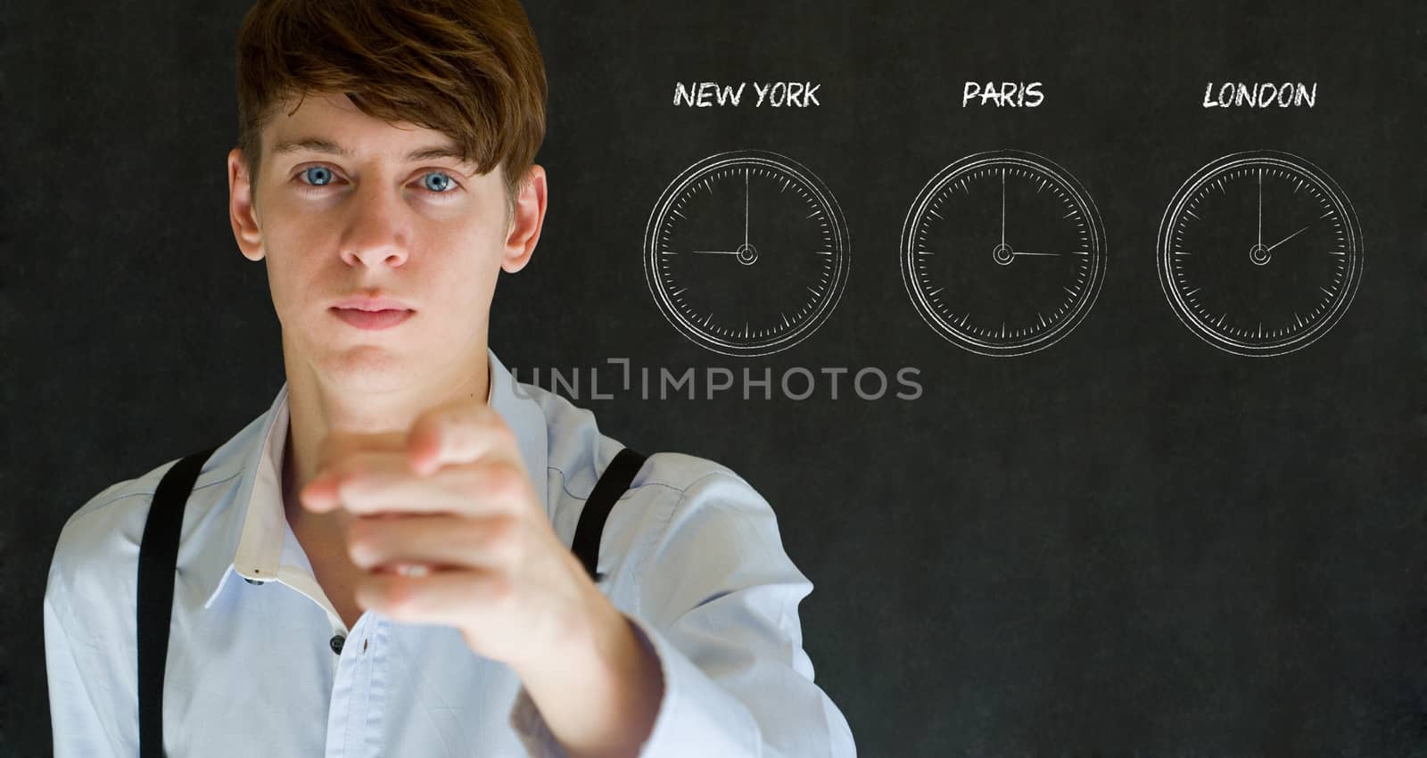 Businessman pointing with New York Paris and London chalk time zone clocks on blackboard background