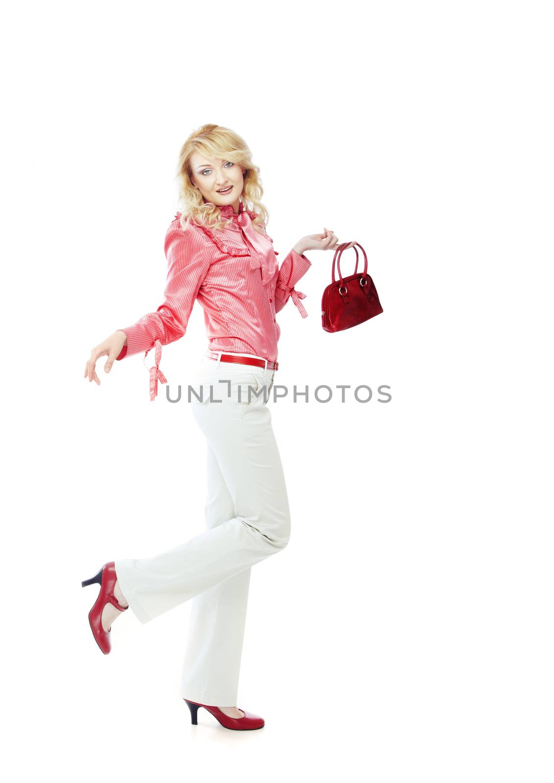 Fashionable lady in shirts and trousers holding red bag
