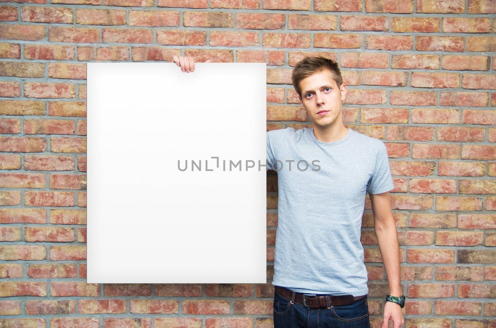 Young man holding blank whiteboard on business presentation