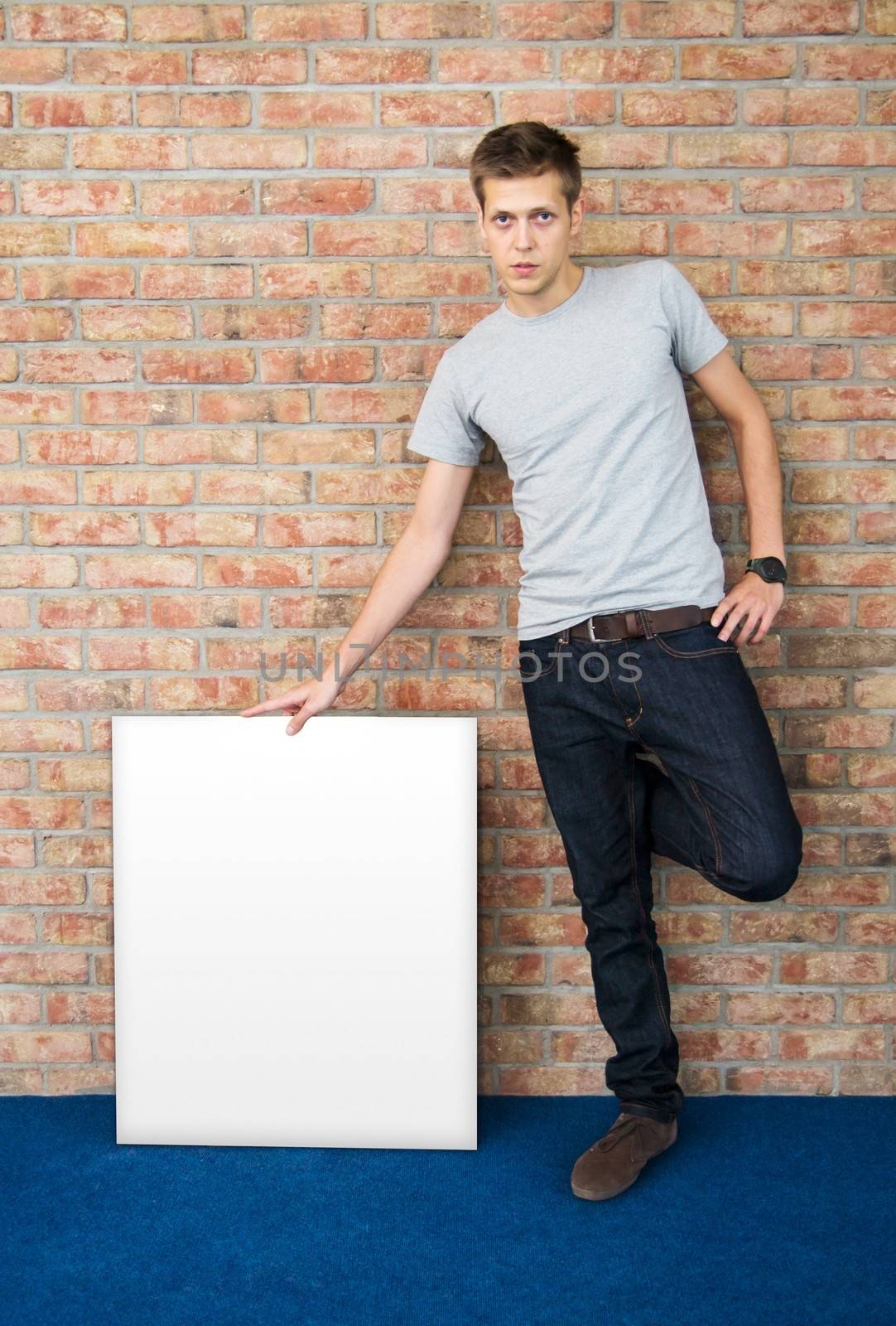 Young man holding blank whiteboard by simpson33