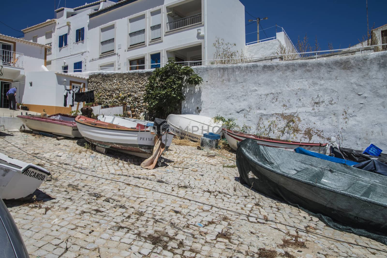 small fishing boats on land by steirus