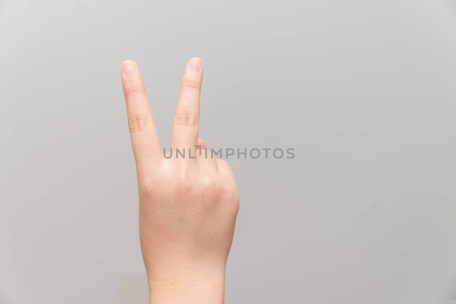 Hand with two fingers up by IVYPHOTOS