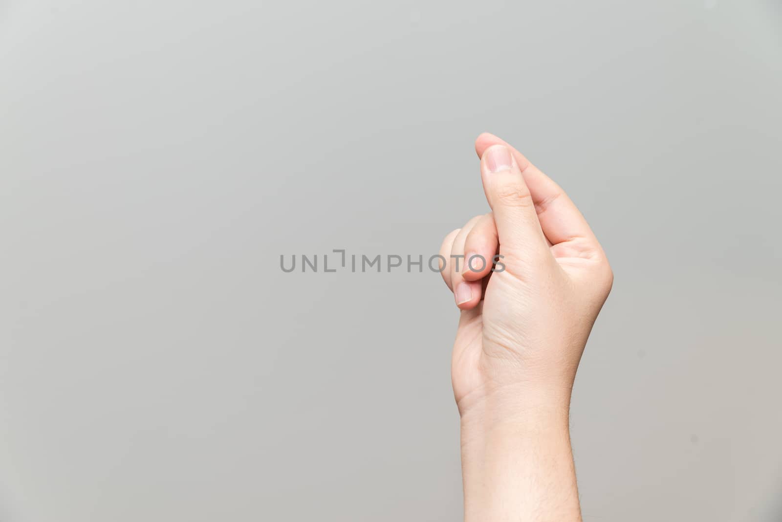 Human hand holding imaginary card on light gray background