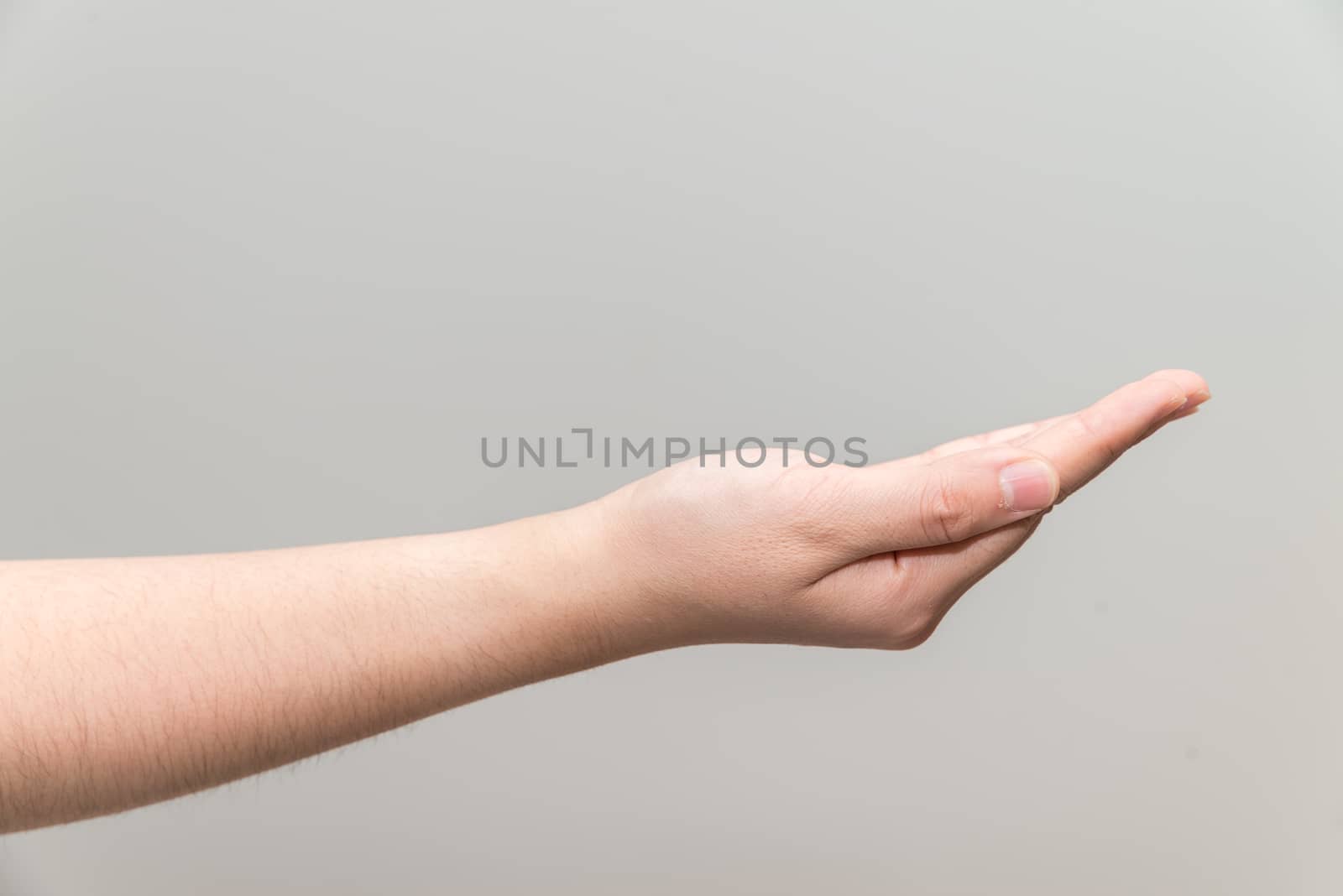 Human hand with open palm ready to recieve on light gray background
