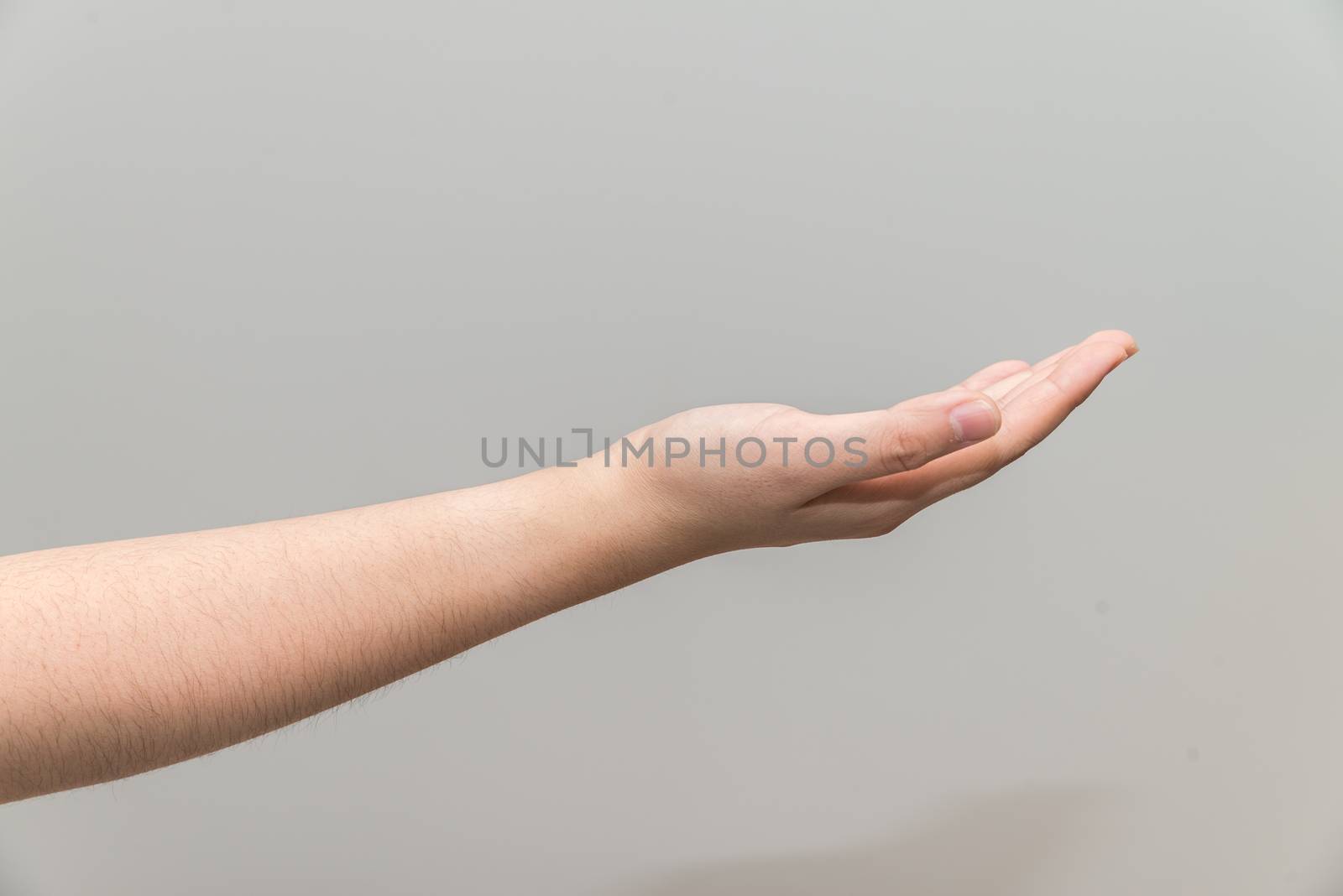 Human hand with open palm ready to recieve on light gray background