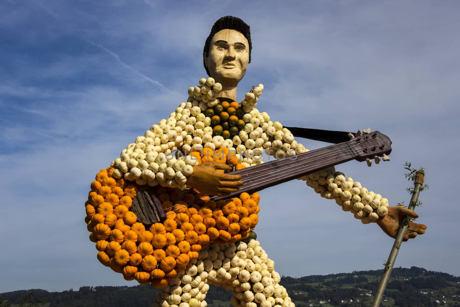 Guitar and guitarist made of small, colourful pumpkins