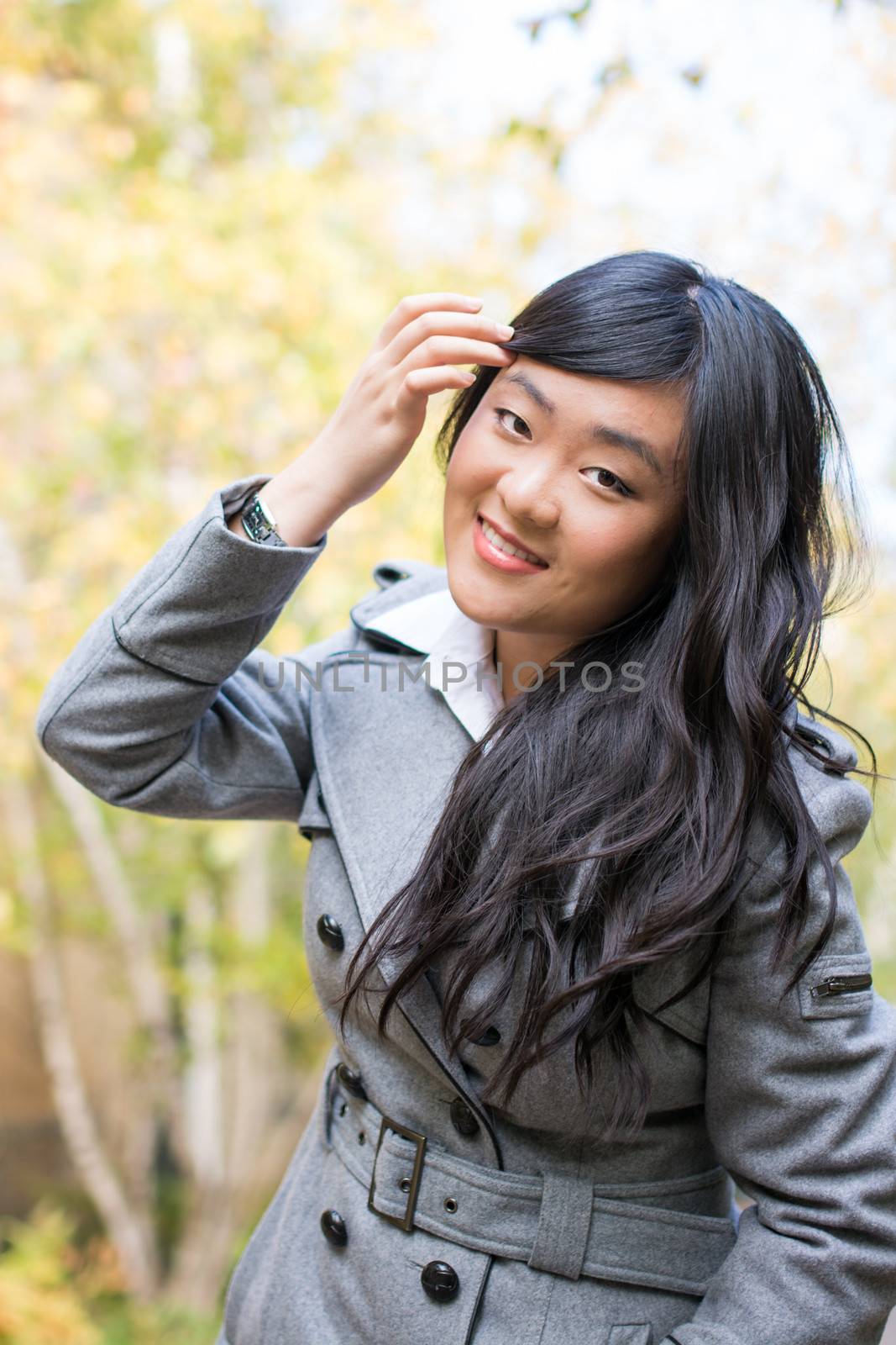 Portrait of young beautiful girl bending forward and tilting her head