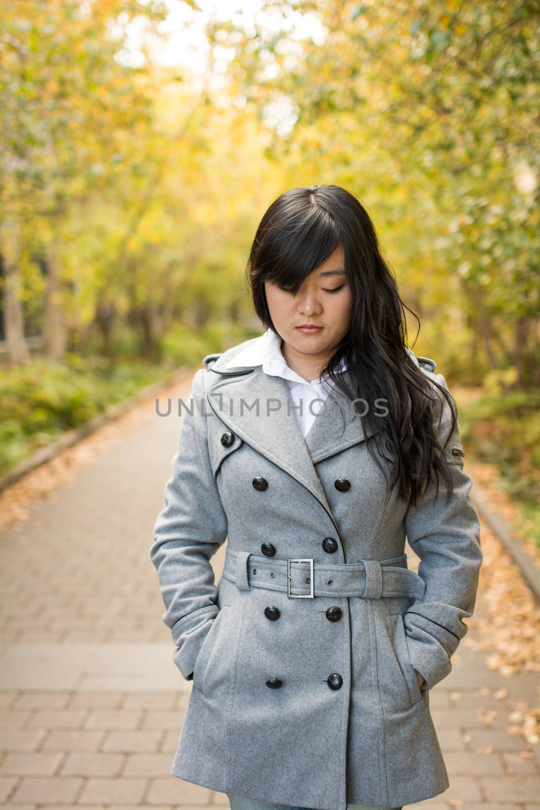 Close up portrait of attractive young girl alone on a road looking depressed