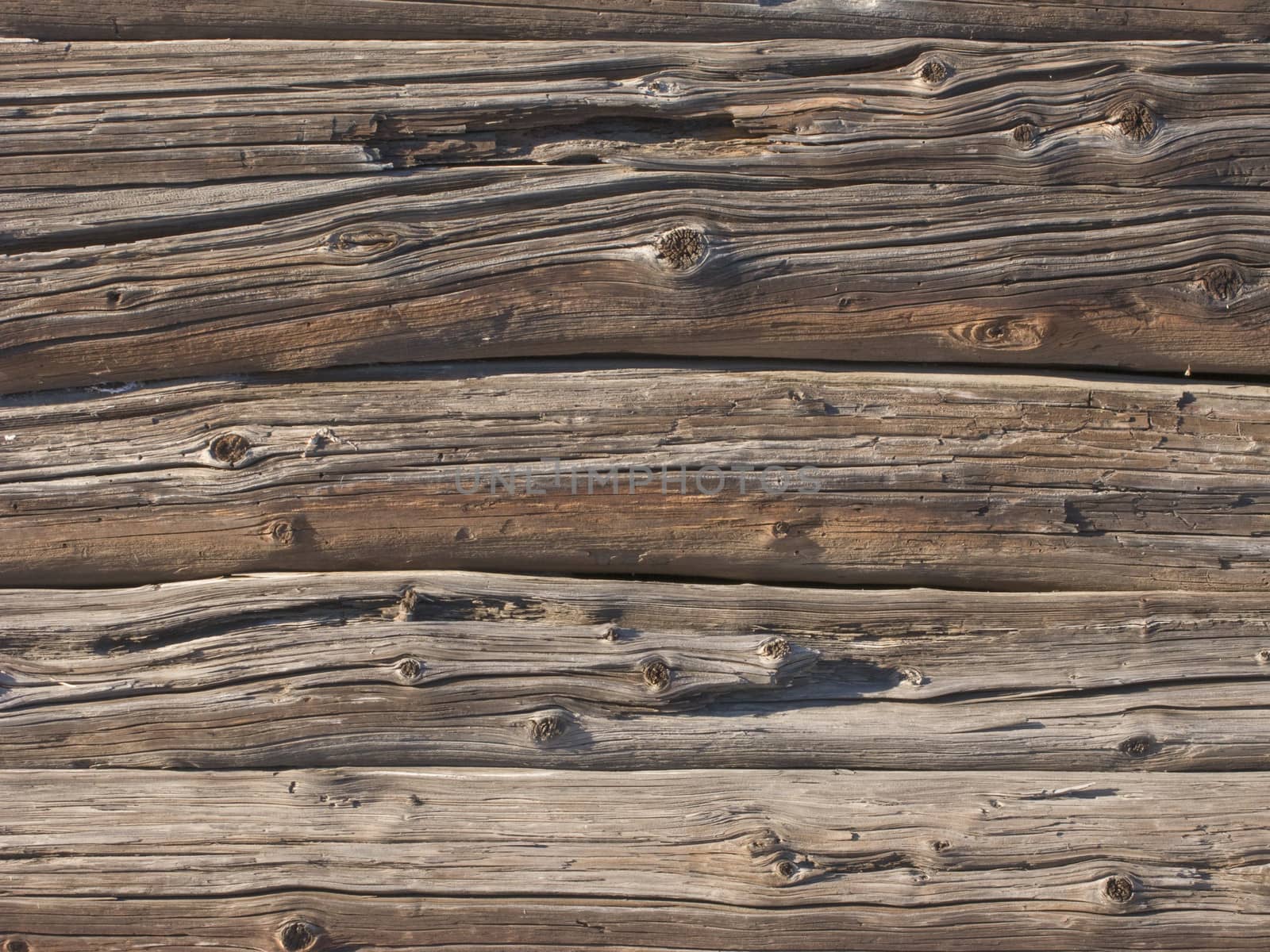 Fragment of old weathered log wall background
