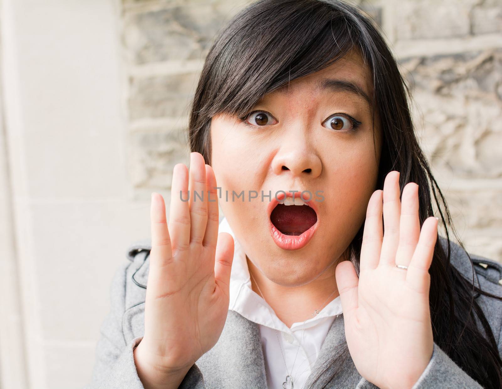 Portrait of woman looking surprised by IVYPHOTOS