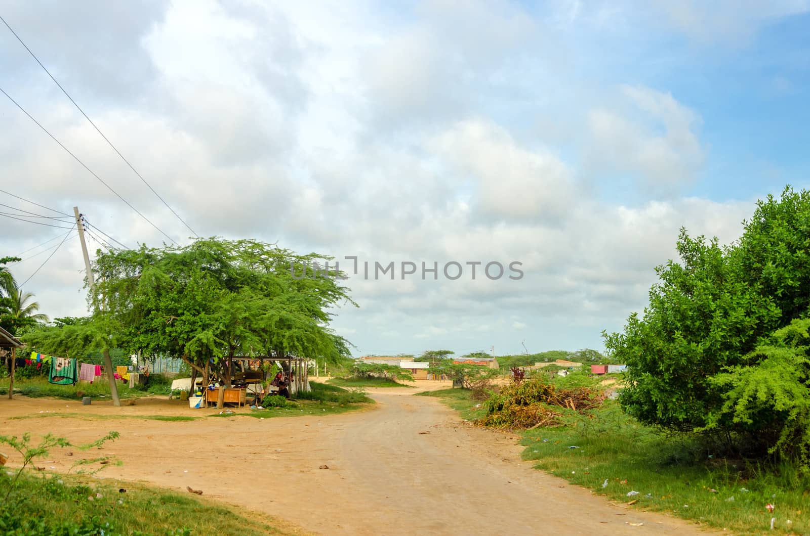 Dirt road passing through a rural village in La Guajira, Colombia