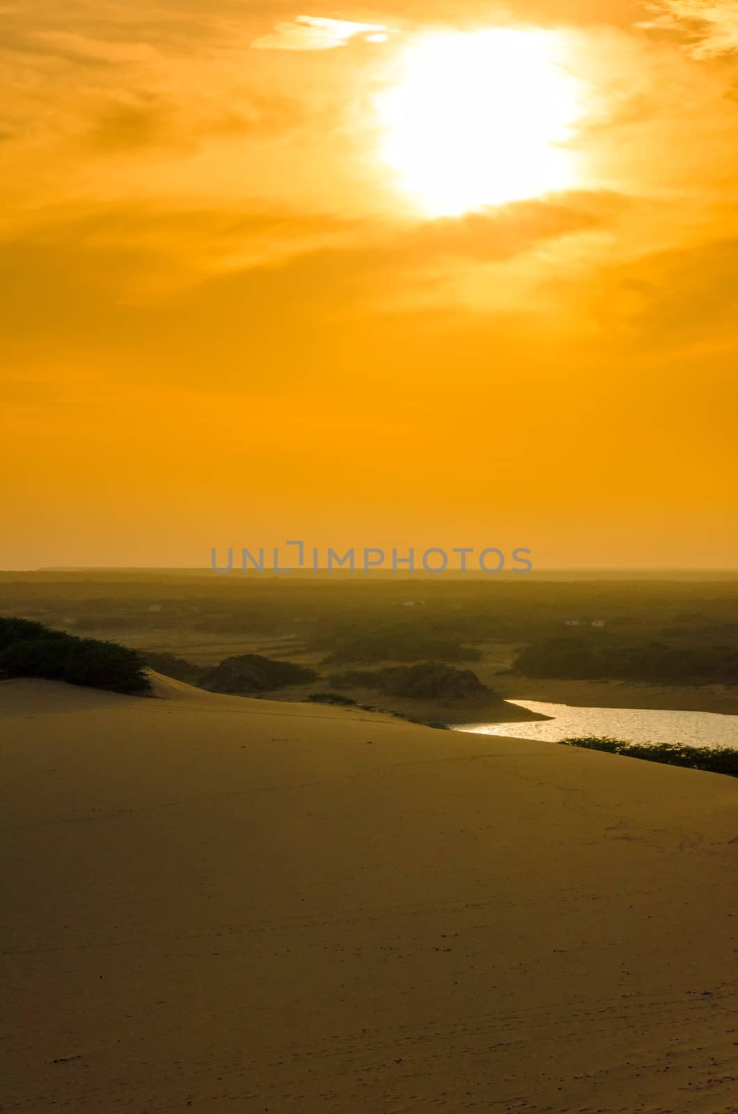 Bright orange sunset over a sand dune in La Guajira, Colombia