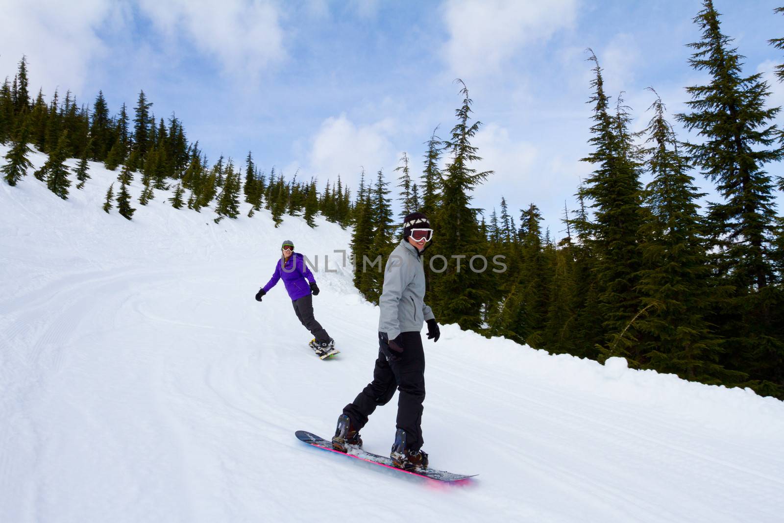 Two People Snowboarding Together by joshuaraineyphotography