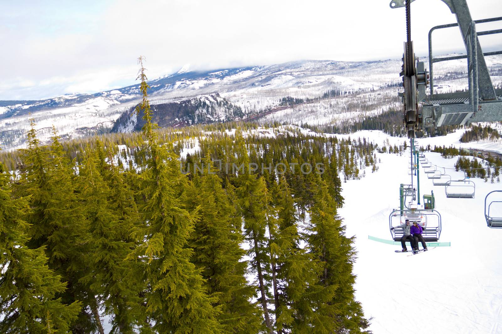 Couple on Ski Lift by joshuaraineyphotography