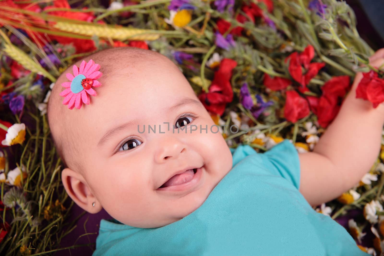 portrait of a beautiful baby with a flower on her head