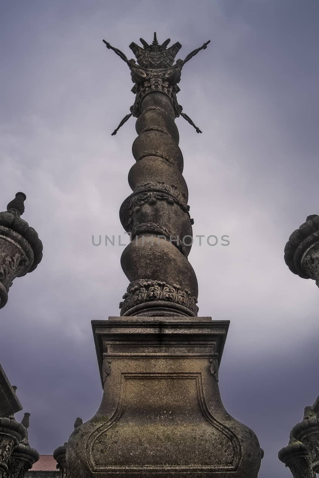 Oporto, December 2012. Solomonic column outside the Oporto cathedral. XII - XIII centuries in romanesque style. Alteration in XVIII century on baroque style. Oporto downtown is UNESCO World Heritage site.