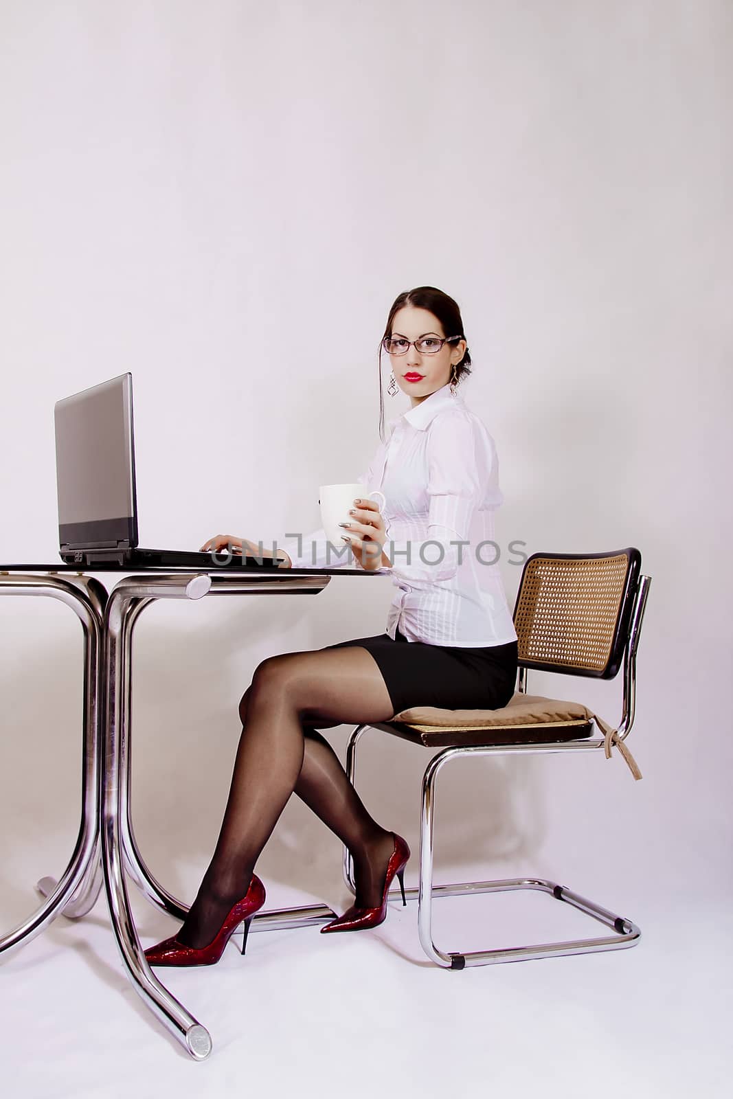 Businesswoman sitting at desk by dukibu
