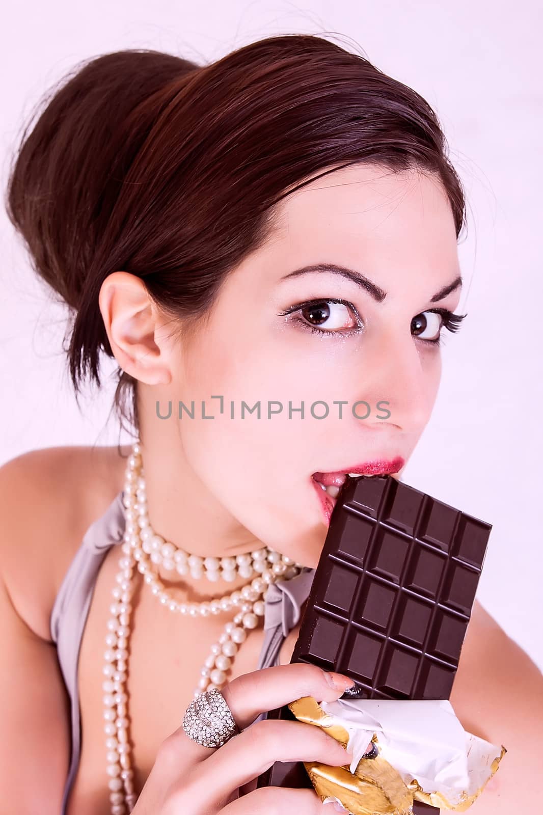 portrait of beautiful girl eating chocolate